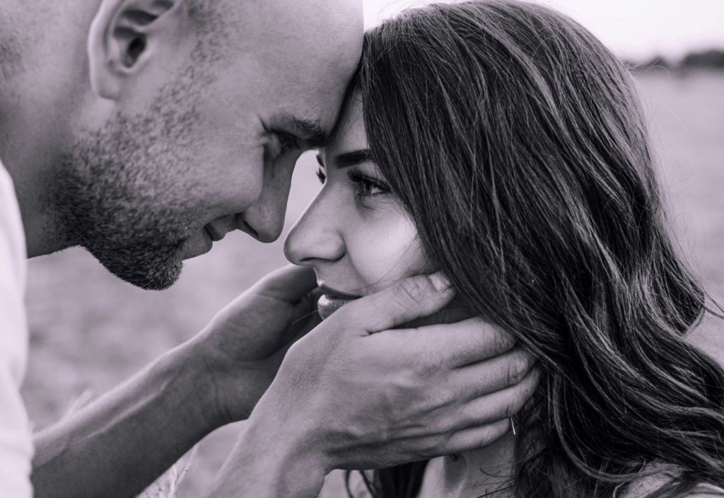 A photo of a man leaning his head on a woman