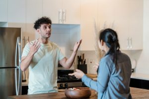 a couple quarreling in the kitchen reflecting the need for healthy fights in relationships